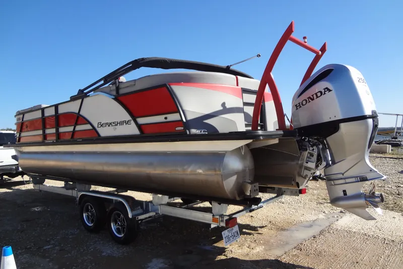 Slide: The Image of 2022 Berkshire 25RFX STS 3.0 pontoon boat with Honda outboard motor on trailer. - 58