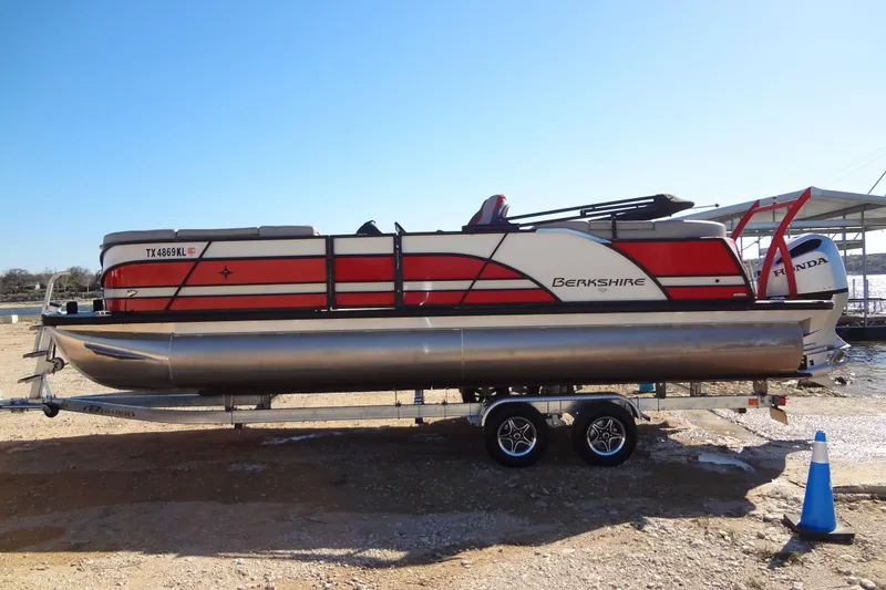Slide: The Image of 2022 Berkshire 25RFX STS 3.0 pontoon boat on trailer, red and white design. - 59