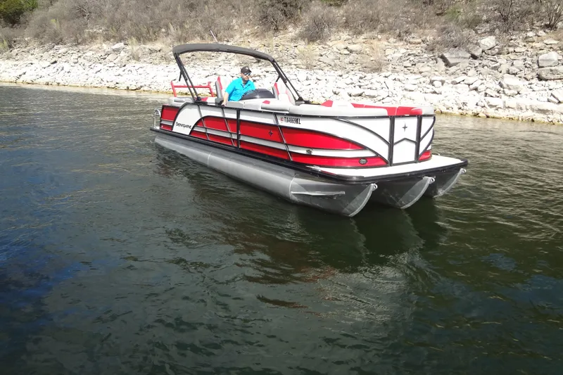 Slide: The Image of 2022 Berkshire 25RFX STS 3.0 pontoon boat on a calm lake. - 6