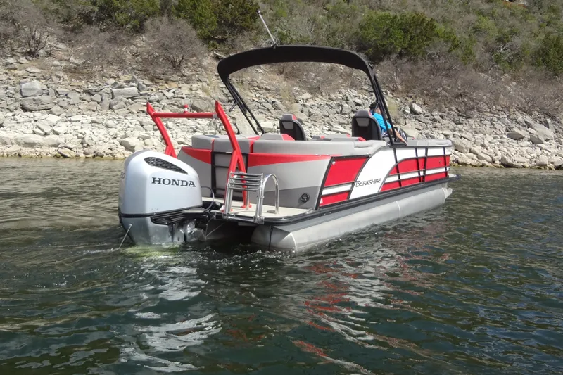 Slide: The Image of 2022 Berkshire 25RFX STS 3.0 pontoon boat with Honda engine on a lake. - 8