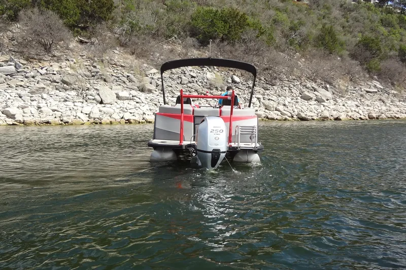 Slide: The Image of 2022 Berkshire 25RFX STS 3.0 pontoon boat on a scenic lake. - 9