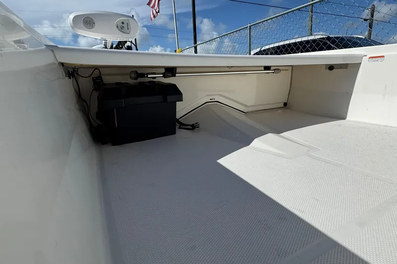 Slide: The Image of 2018 Mako Pro Skiff 17 CC interior with storage compartment and equipment. - 3