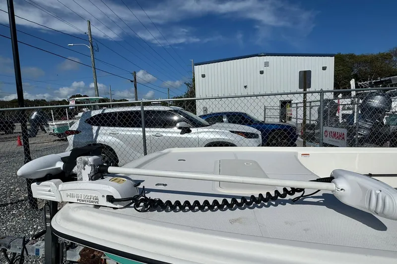 Slide: The Image of 2018 Mako Pro Skiff 17 CC with Minn Kota PowerDrive motor in a parking lot. - 4