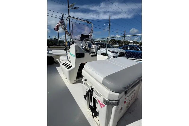 Slide: The Image of 2018 Mako Pro Skiff 17 CC boat interior with steering console and cooler seat. - 8