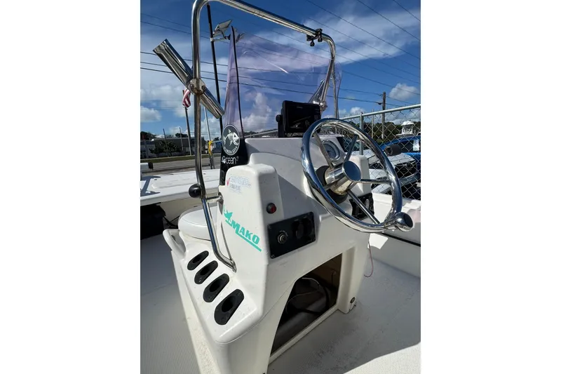 Slide: The Image of 2018 Mako Pro Skiff 17 CC boat console with steering wheel and controls. - 9