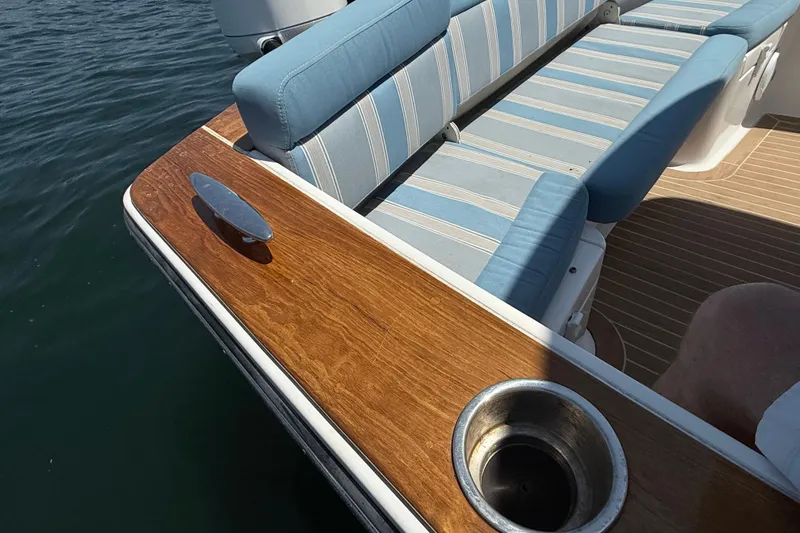 Slide: The Image of 2017 Vanquish Bristol Harbor 23 CC boat with striped seating and wooden deck detail. - 21