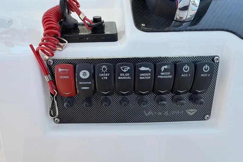 Slide: The Image of Control panel of 2017 Vanquish Bristol Harbor 23 CC boat with labeled switches. - 29