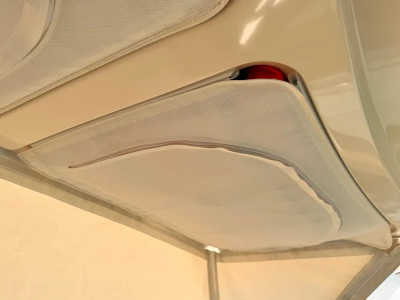 Slide: The Image of 2014 Pursuit OS 385 Offshore boat interior ceiling storage compartment. - 18