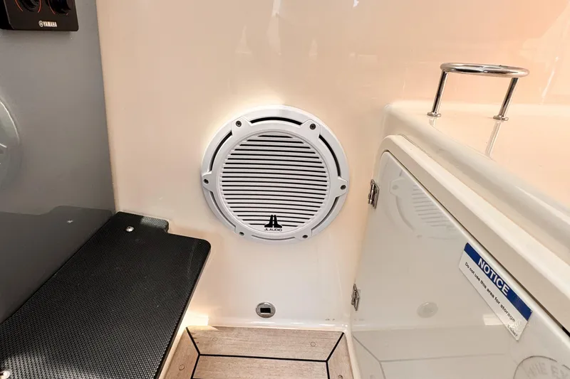 Slide: The Image of 2014 Pursuit OS 385 Offshore interior with speaker and storage compartment. - 24
