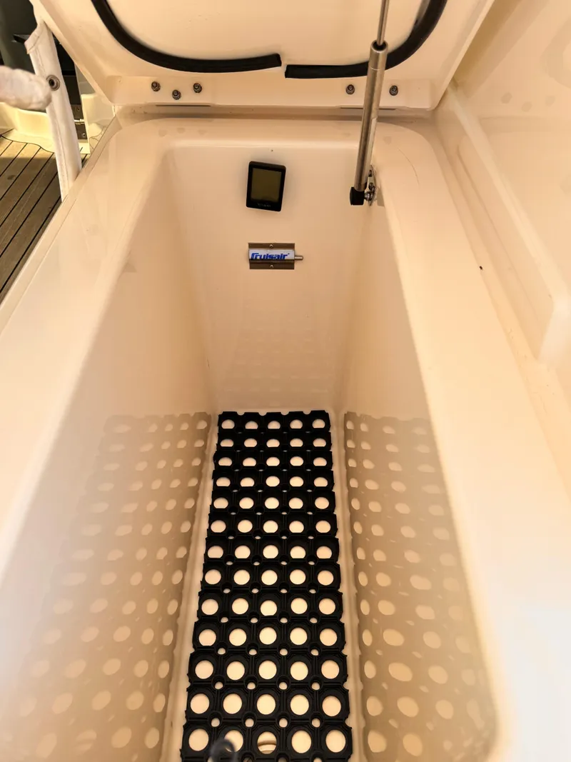 Slide: The Image of 2014 Pursuit OS 385 Offshore storage compartment with non-slip mat and hydraulic lift. - 29