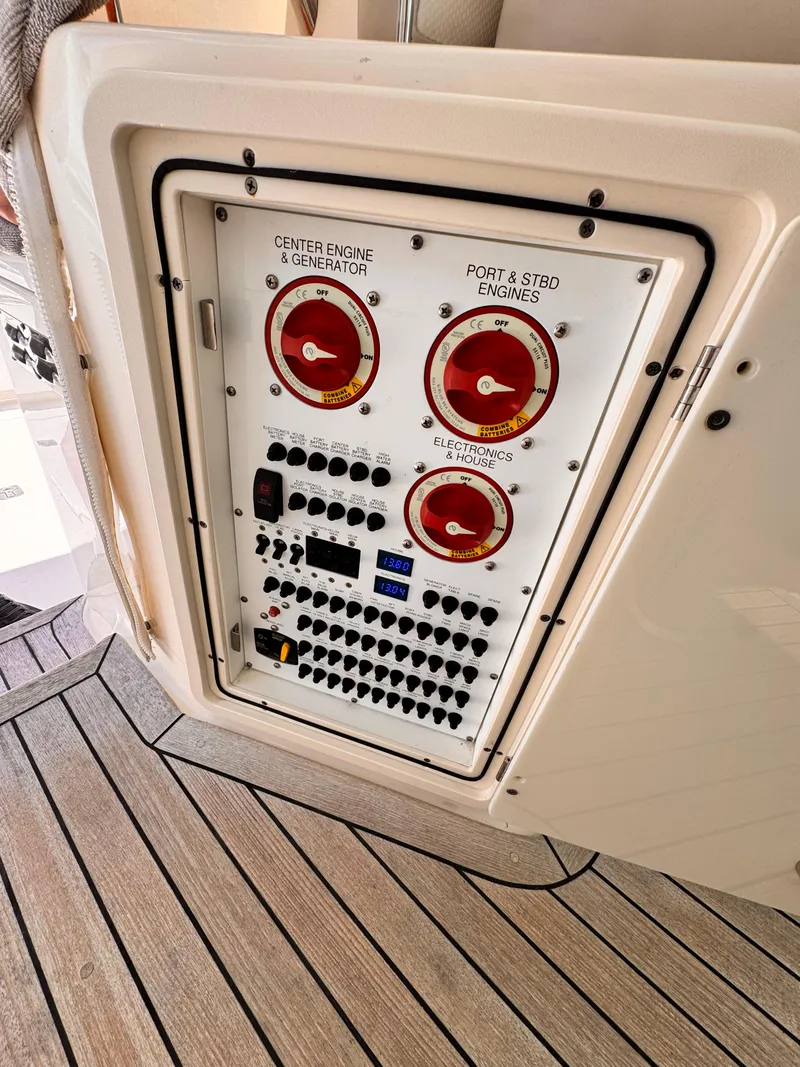 Slide: The Image of Control panel on 2014 Pursuit OS 385 Offshore boat, featuring engine and generator switches. - 30