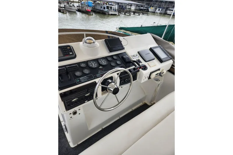 Slide: The Image of 1996 Silverton 34 Motor Yacht helm with steering wheel and navigation instruments. - 11