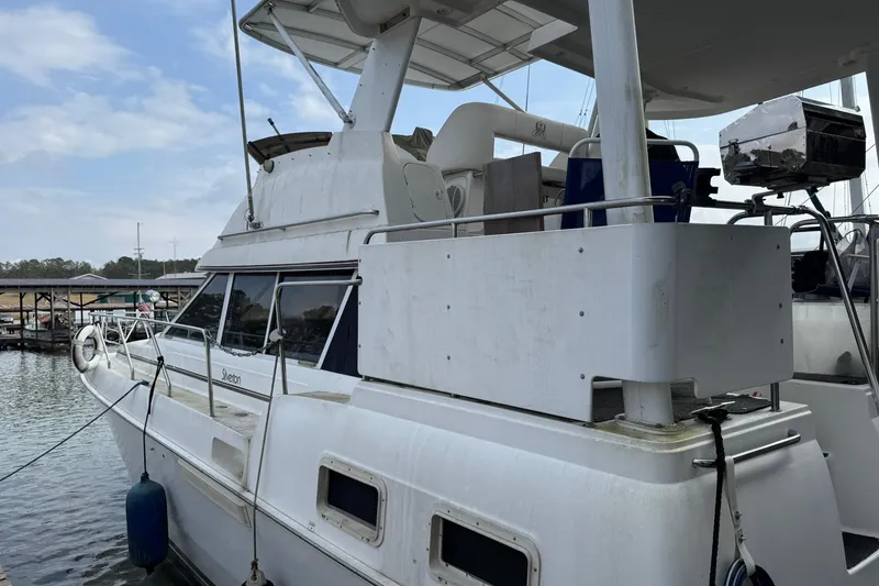 Slide: The Image of 1996 Silverton 34 Motor Yacht docked at marina, side view with upper deck. - 2
