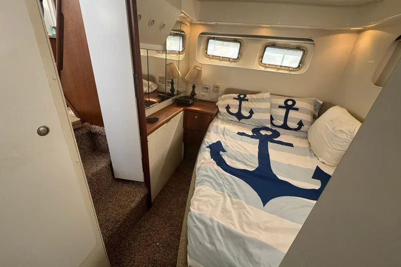 Slide: The Image of Cozy bedroom in 1996 Silverton 34 Motor Yacht with nautical-themed bedding. - 26