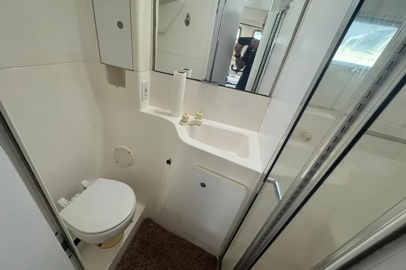 Slide: The Image of Bathroom interior of 1996 Silverton 34 Motor Yacht with toilet and sink. - 27