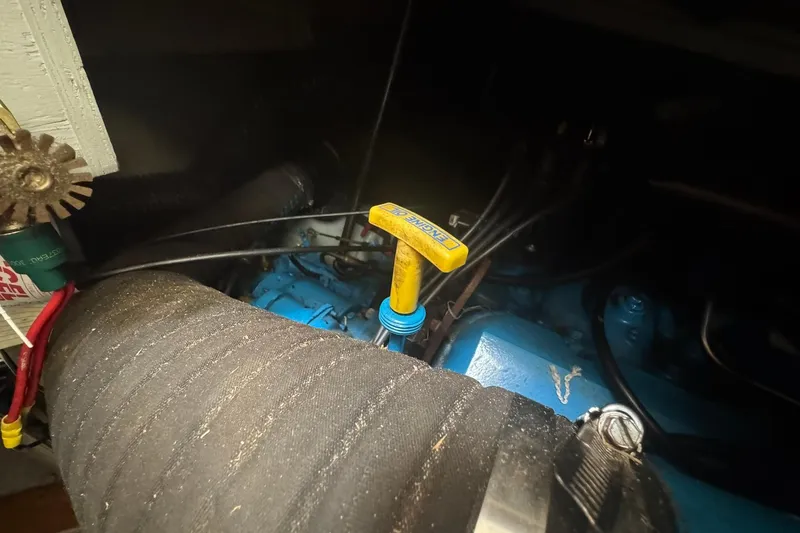 Slide: The Image of Engine compartment of a 1996 Silverton 34 Motor Yacht, featuring a blue engine. - 29