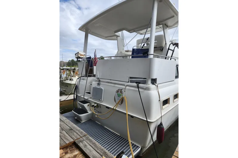 Slide: The Image of 1996 Silverton 34 Motor Yacht docked, rear view with deck and equipment. - 3