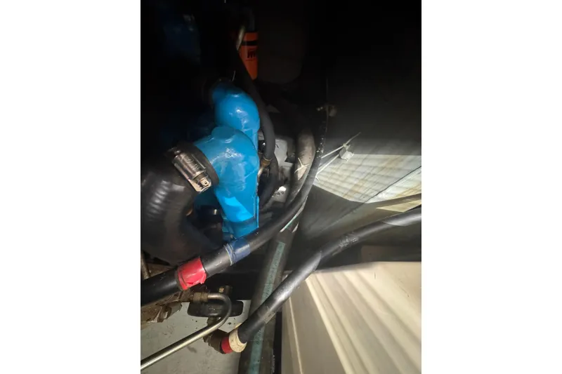 Slide: The Image of Engine compartment of a 1996 Silverton 34 Motor Yacht with visible hoses and components. - 30