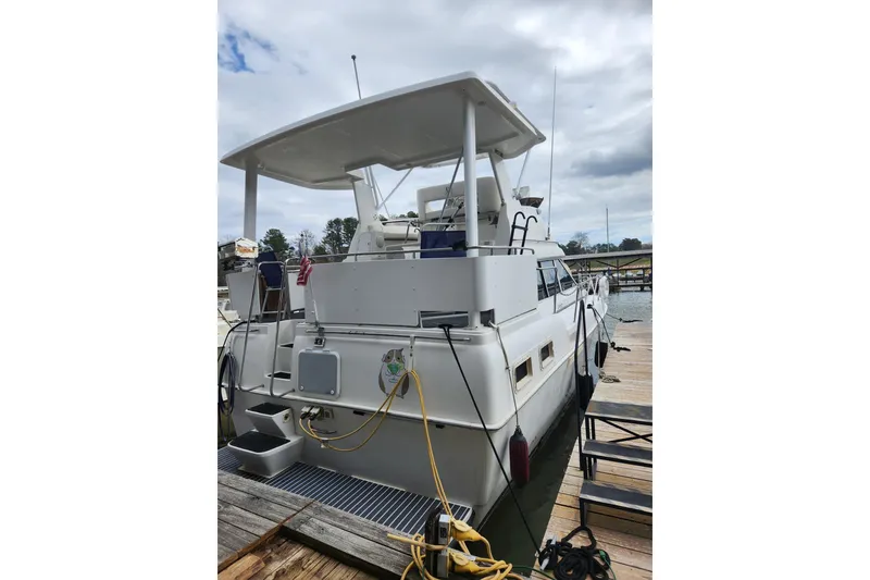 Slide: The Image of 1996 Silverton 34 Motor Yacht docked, rear view with canopy and equipment. - 4