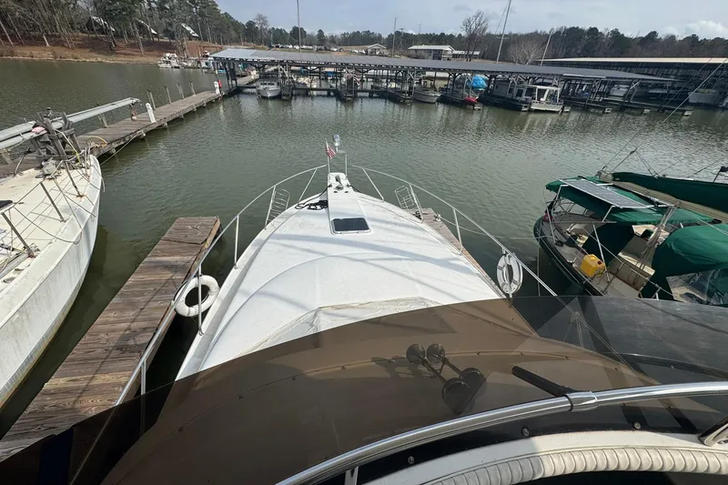 Slide: The Image of 1996 Silverton 34 Motor Yacht docked at a marina, surrounded by other boats. - 6