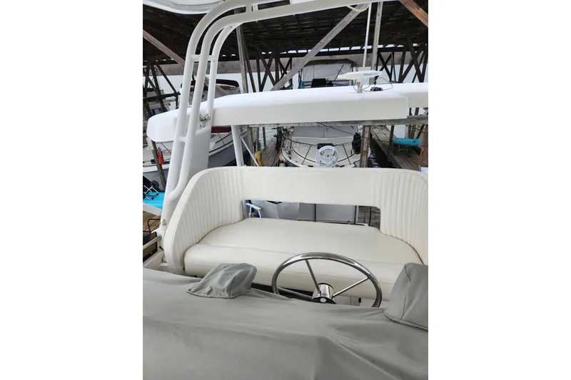 Slide: The Image of 1996 Silverton 34 Motor Yacht helm with white seating and steering wheel. - 9
