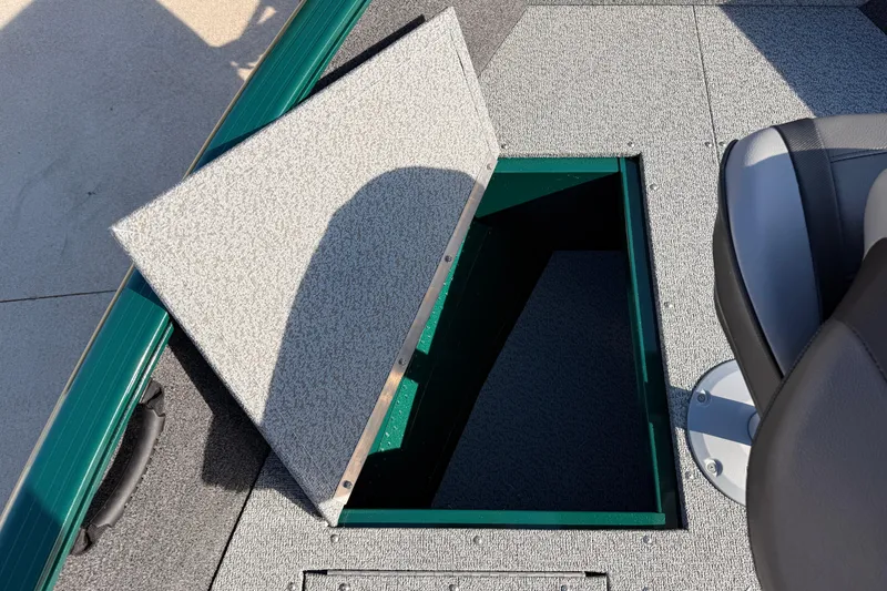 Slide: The Image of 2026 Lund 1650 Rebel XL SS boat with open storage compartment and seating. - 10