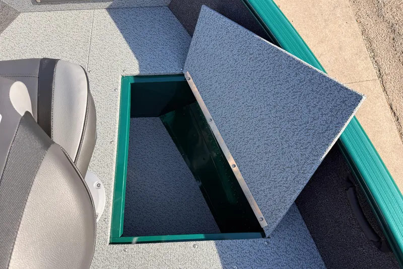 Slide: The Image of 2026 Lund 1650 Rebel XL SS boat with open storage compartment and seat. - 11