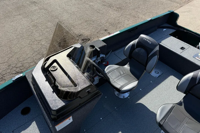 Slide: The Image of 2026 Lund 1650 Rebel XL SS boat interior with steering console and seating. - 15
