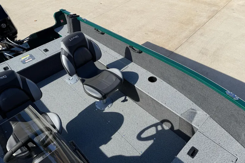 Slide: The Image of 2026 Lund 1650 Rebel XL SS boat interior with seating and steering wheel. - 18