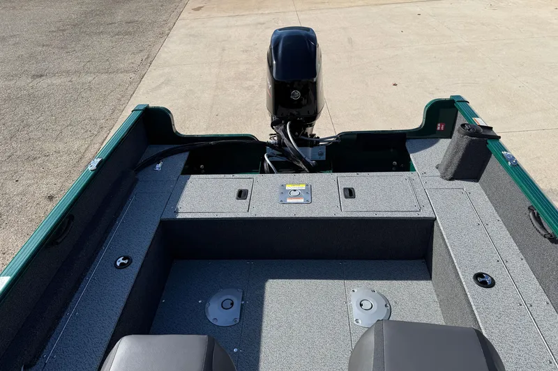 Slide: The Image of 2026 Lund 1650 Rebel XL SS boat interior with motor, featuring spacious seating and storage. - 20