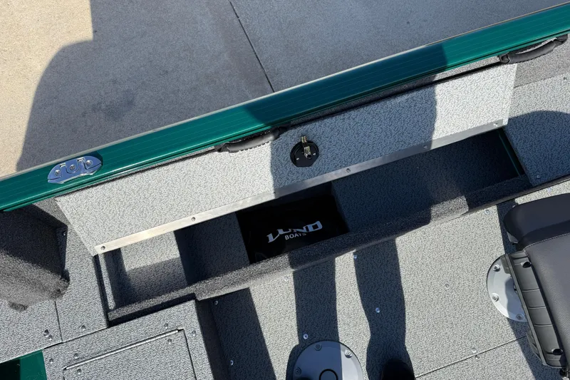 Slide: The Image of 2026 Lund 1650 Rebel XL SS boat interior with storage compartments and seating. - 21