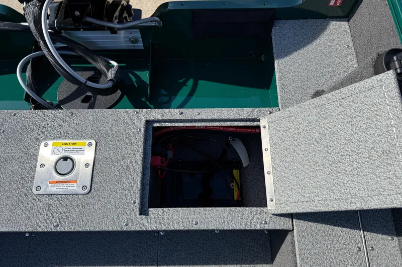 Slide: The Image of 2026 Lund 1650 Rebel XL SS boat interior with open storage compartment and wiring. - 25