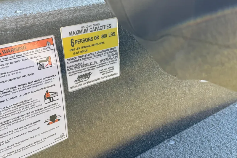Slide: The Image of US Coast Guard capacity label on 2026 Lund 1650 Rebel XL SS boat. - 26