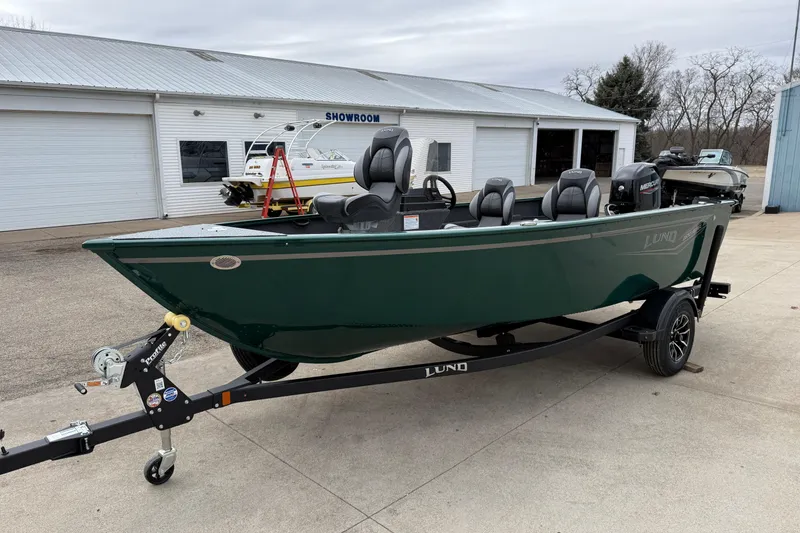Slide: The Image of 2026 Lund 1650 Rebel XL SS boat on trailer outside showroom. - 3