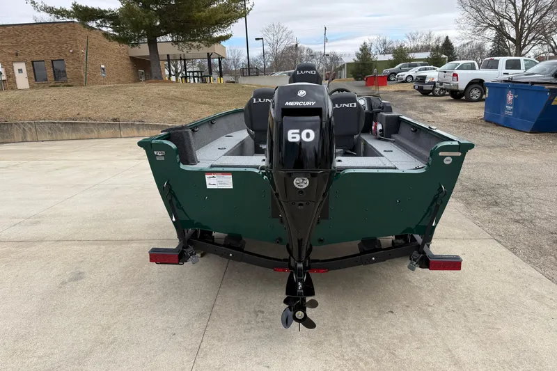 Slide: The Image of 2026 Lund 1650 Rebel XL SS boat with Mercury 60 engine, parked outdoors. - 5