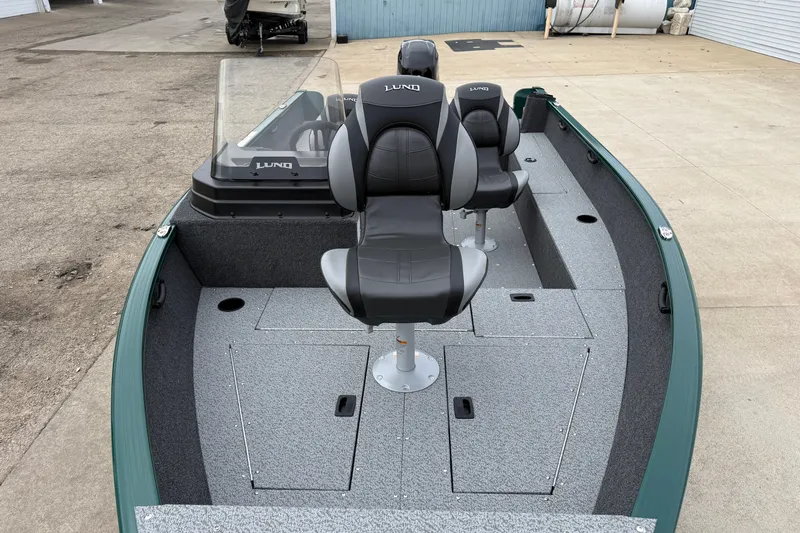 Slide: The Image of 2026 Lund 1650 Rebel XL SS boat interior with seating and storage compartments. - 7