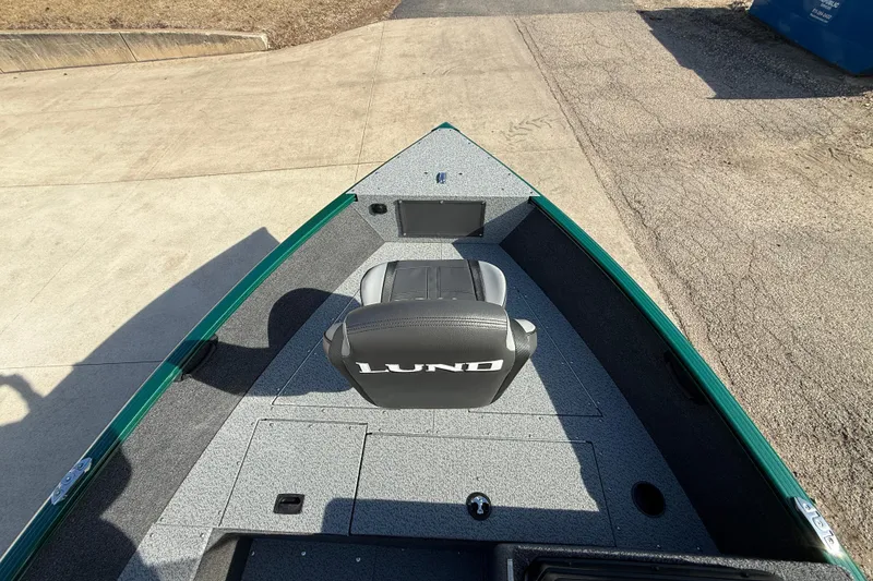 Slide: The Image of 2026 Lund 1650 Rebel XL SS boat interior with seating and storage compartments. - 9