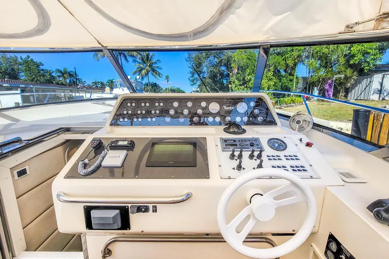 Slide: The Image of Cockpit of a 1998 Baia Sports Cruiser with steering wheel and instruments. - 13
