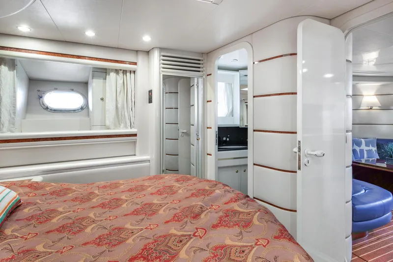 Slide: The Image of Interior of a 1998 Baia Sports Cruiser yacht, bedroom with bed and window. - 22