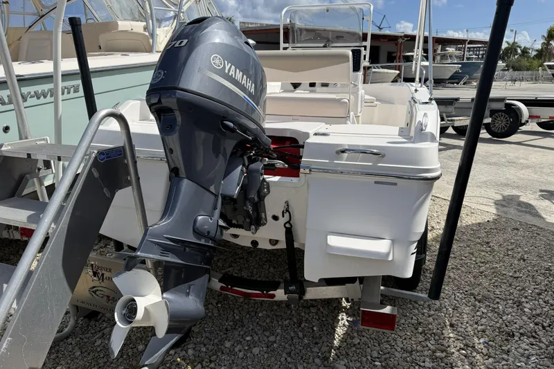 Slide: The Image of 2017 Robalo R160 Center Console with Yamaha outboard motor, docked on gravel. - 10