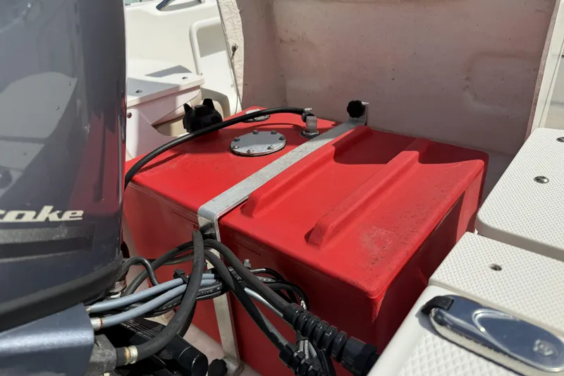 Slide: The Image of 2017 Robalo R160 Center Console boat with red fuel tank and engine components. - 12