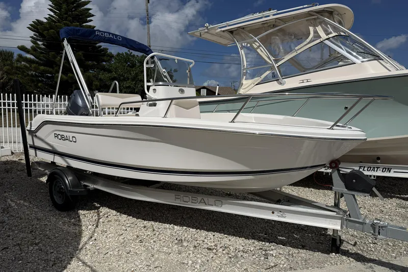Slide: The Image of 2017 Robalo R160 Center Console boat on trailer, parked outdoors. - 3
