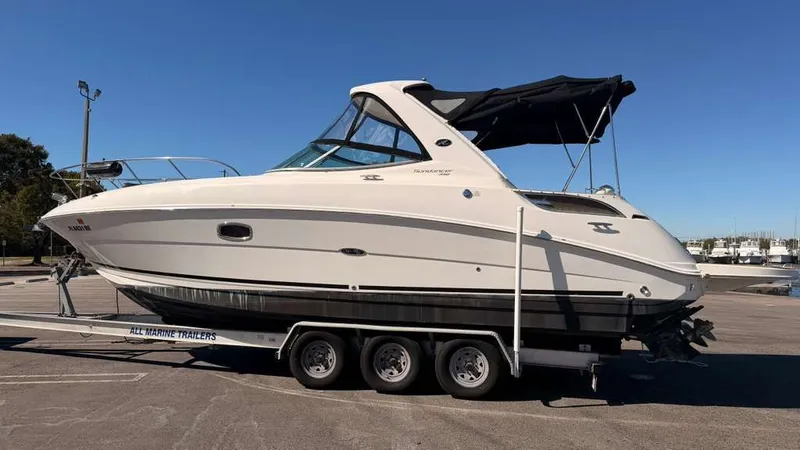 Slide: The Image of 2010 Sea Ray Sundancer 310 on a trailer outdoors. - 10