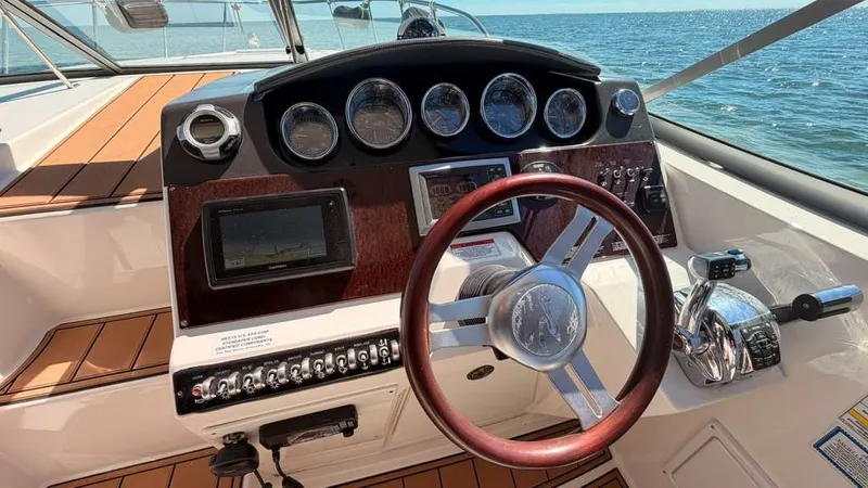 Slide: The Image of Sea Ray Sundancer 310 helm, 2010 model, featuring wooden steering wheel. - 18