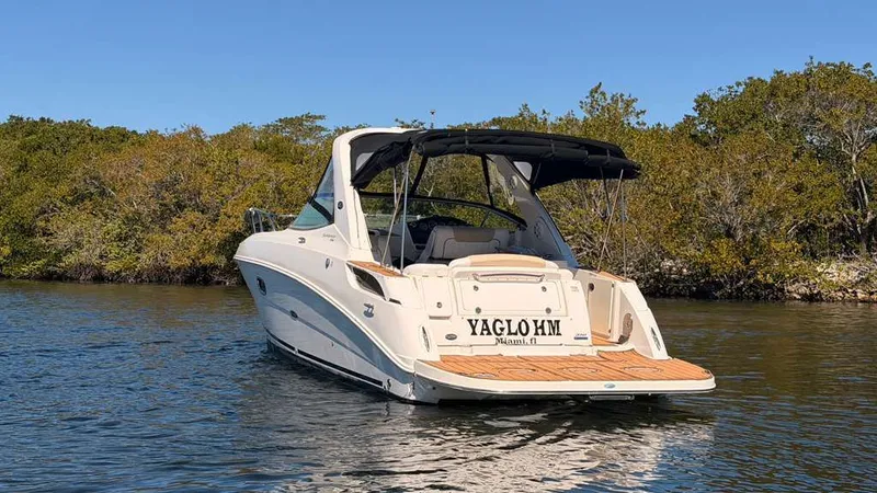 Slide: The Image of 2010 Sea Ray Sundancer 310 on calm water, rear view. - 2