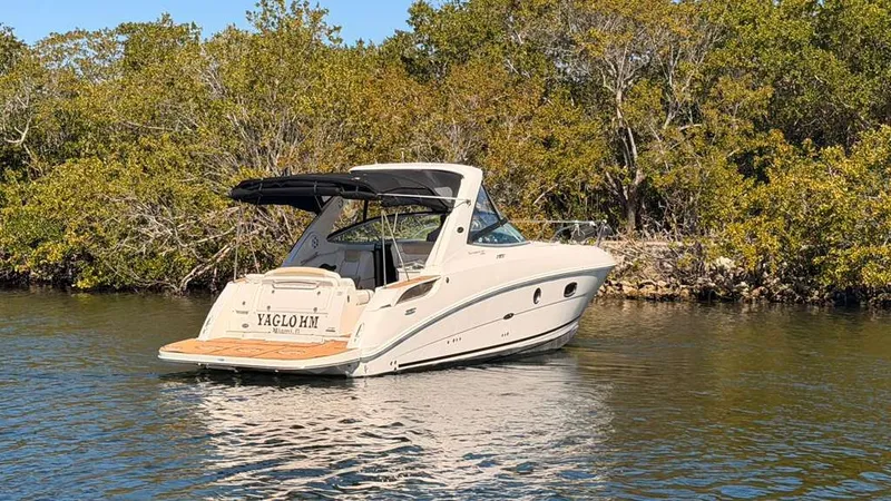 Slide: The Image of 2010 Sea Ray Sundancer 310 on calm water near trees. - 3