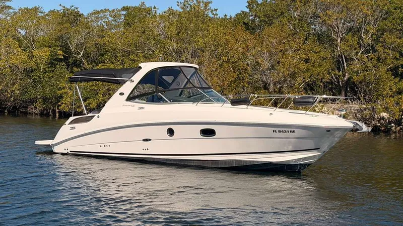 Slide: The Image of 2010 Sea Ray Sundancer 310 on calm water with trees in background. - 5
