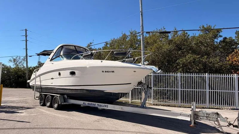 Slide: The Image of 2010 Sea Ray Sundancer 310 on a trailer outdoors. - 9