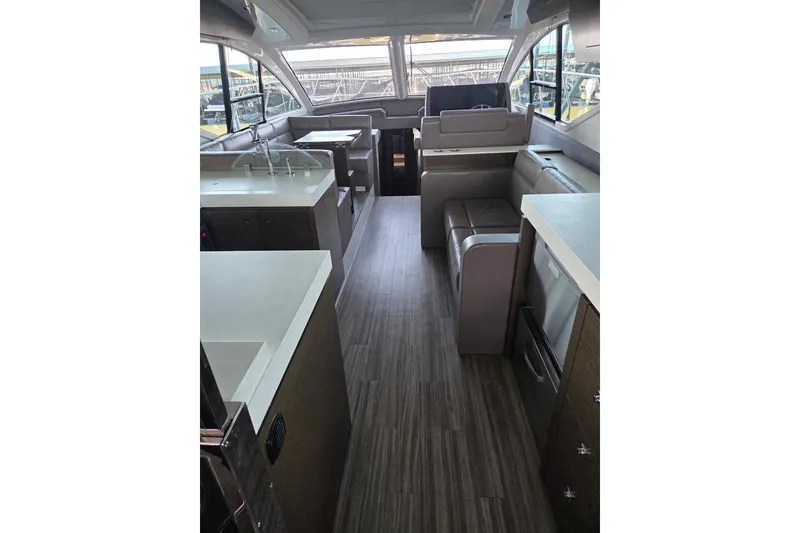 Slide: The Image of Luxurious interior of 2018 Cruisers Yachts 54 Cantius with modern kitchen and seating area. - 12