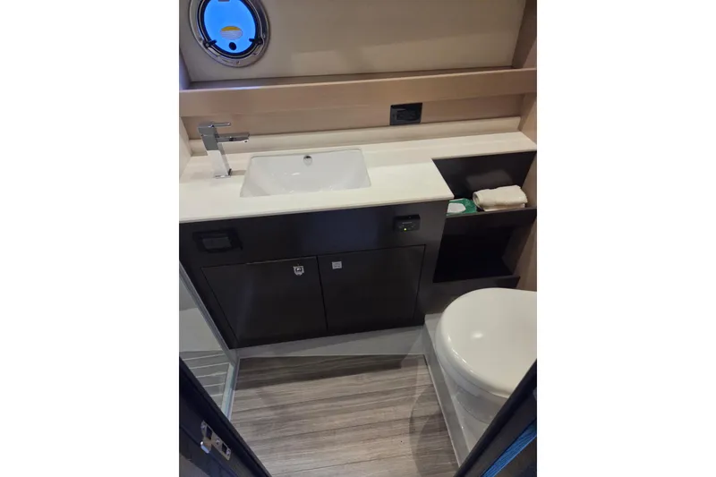 Slide: The Image of Luxurious bathroom in 2018 Cruisers Yachts 54 Cantius with modern fixtures and porthole window. - 19